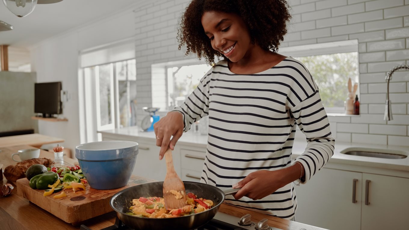 Woman cooking a vegetable omelette