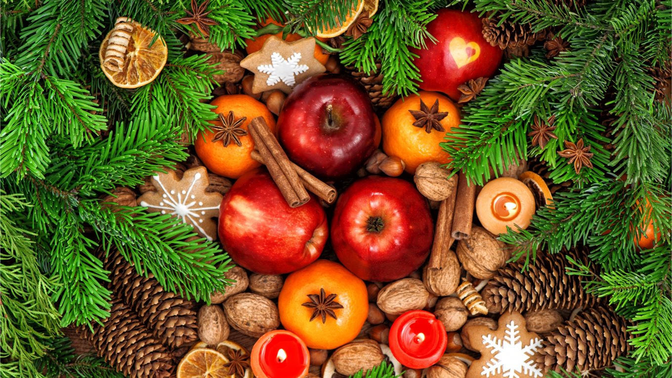 Christmas food: fruits, nuts, spices and cookies.