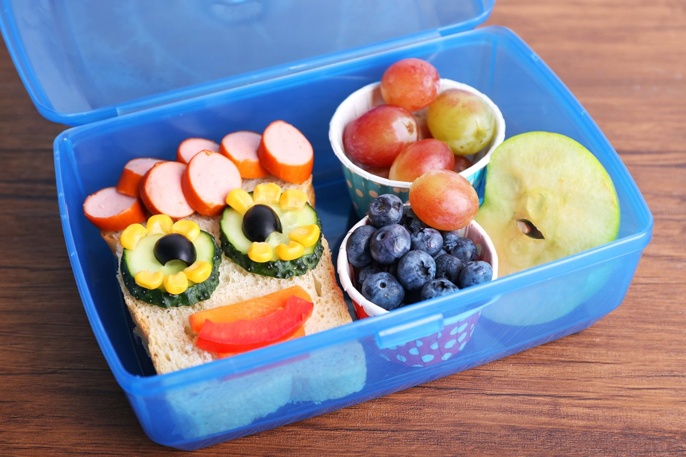 Kid's lunchbox with healthy food arranged in smiley face