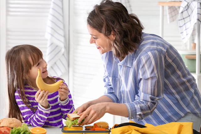 Mum and daughter preparing a lunchbox