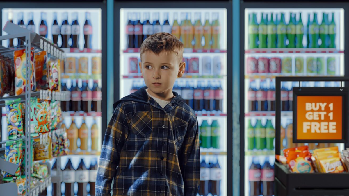 Safefood food environment ad showing young boy in shop surrounded by unhealthy food