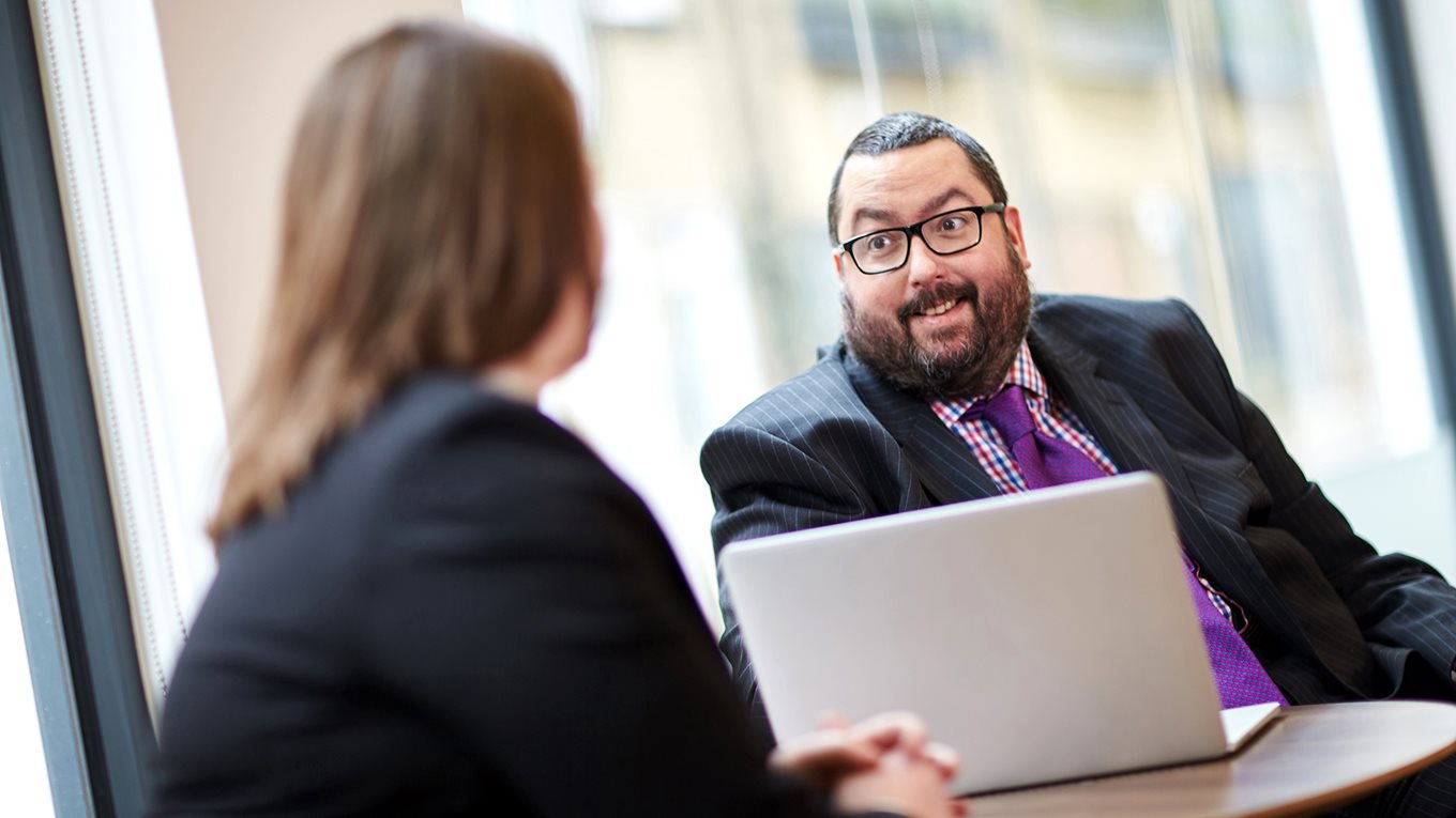 Man at a meeting with a colleague