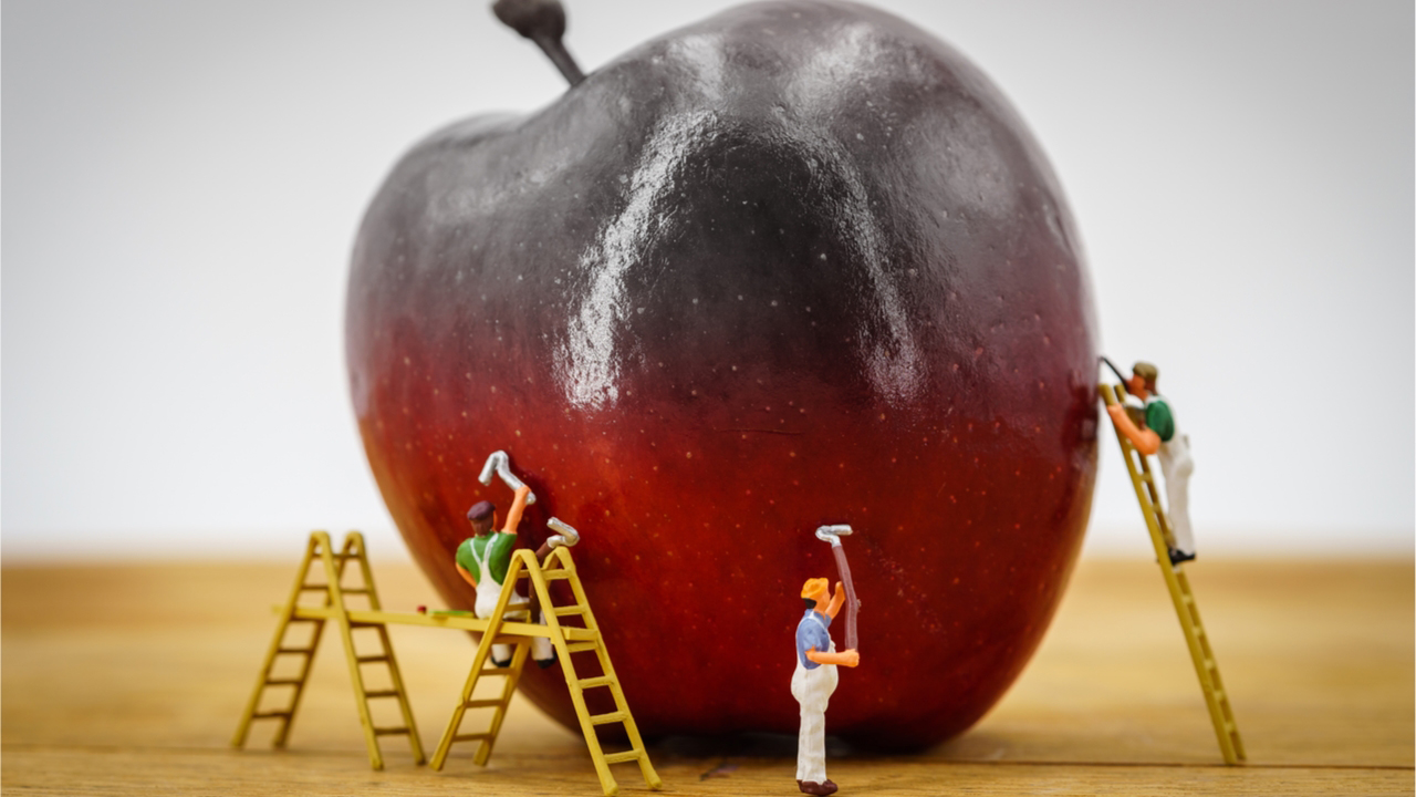 Food fraud concept, painting an apple red