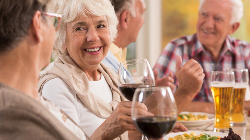 Older people drinking wine and beer with dinner