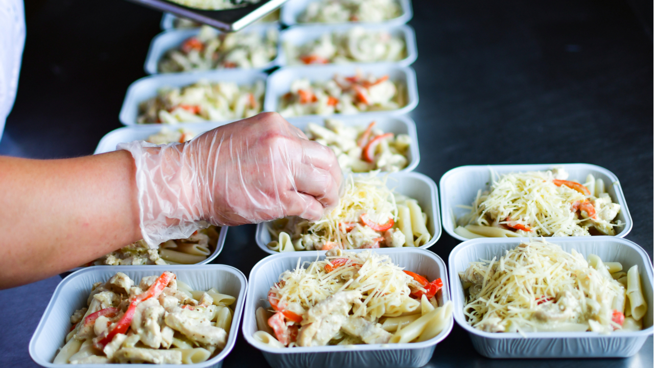 Food worker packaging ready meals