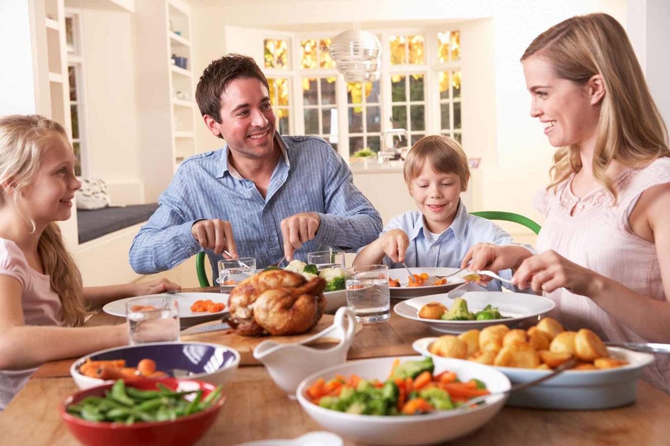 A family eating dinner together at the table