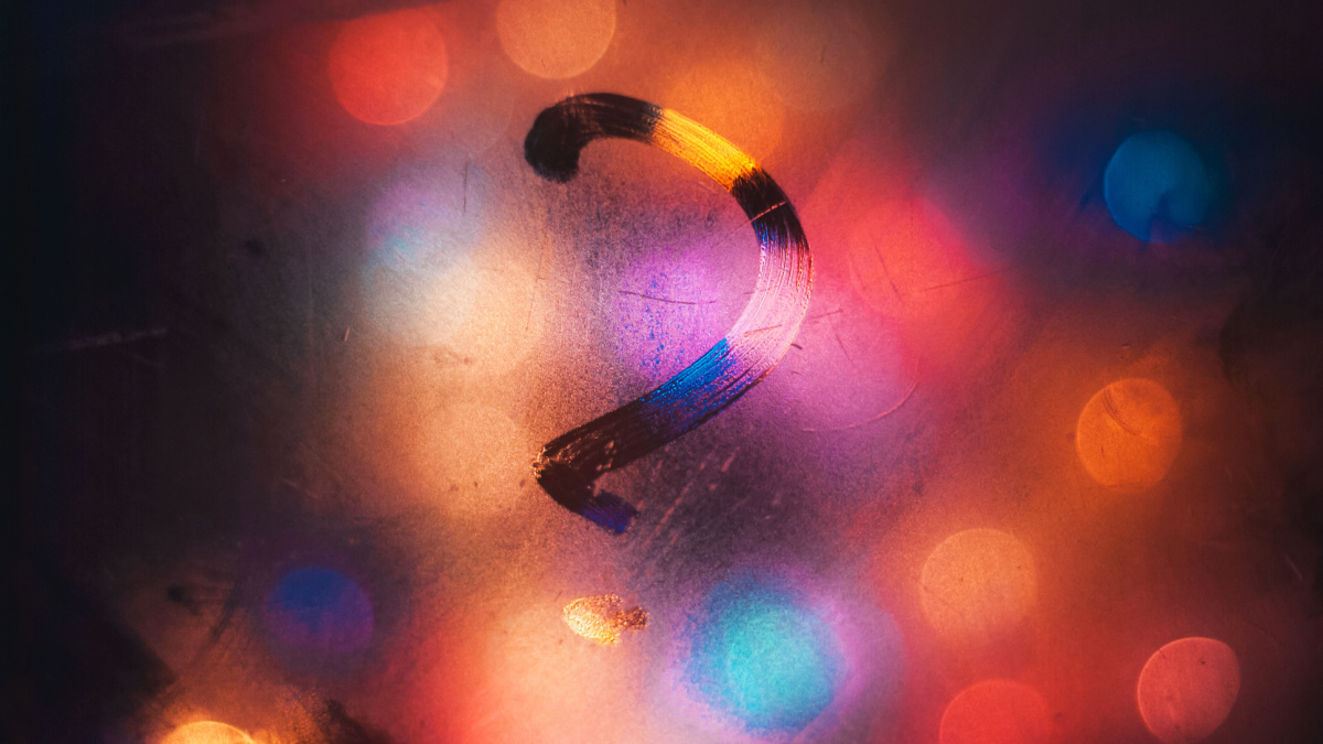 A question mark traced on a foggy window