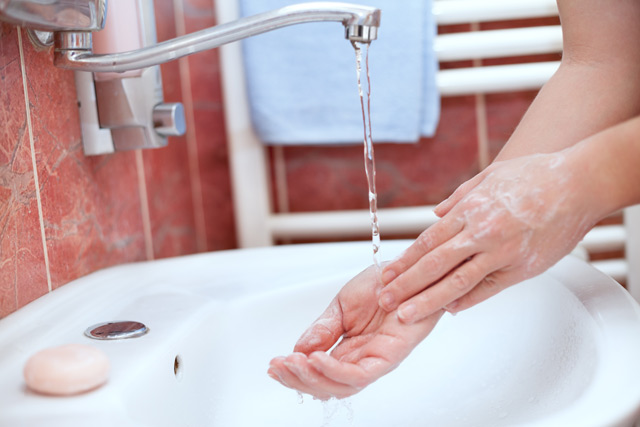rinsing hands under the tap