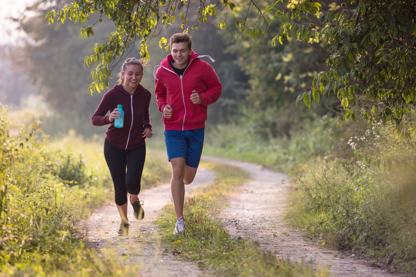 Teenage boy and girl jogging