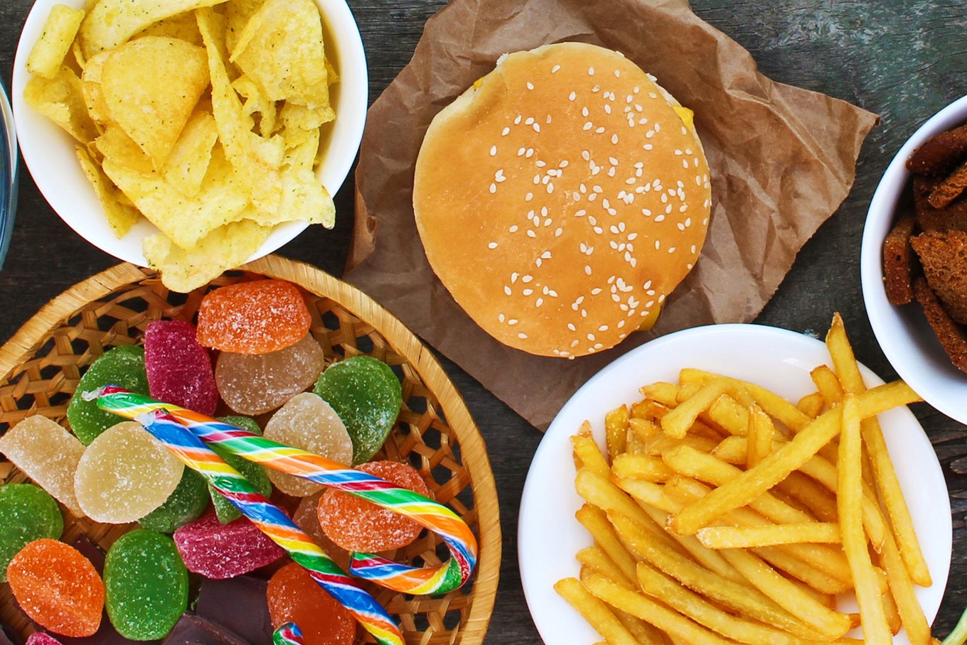 Array of junk food such as crisps, chips, sweets and burgers