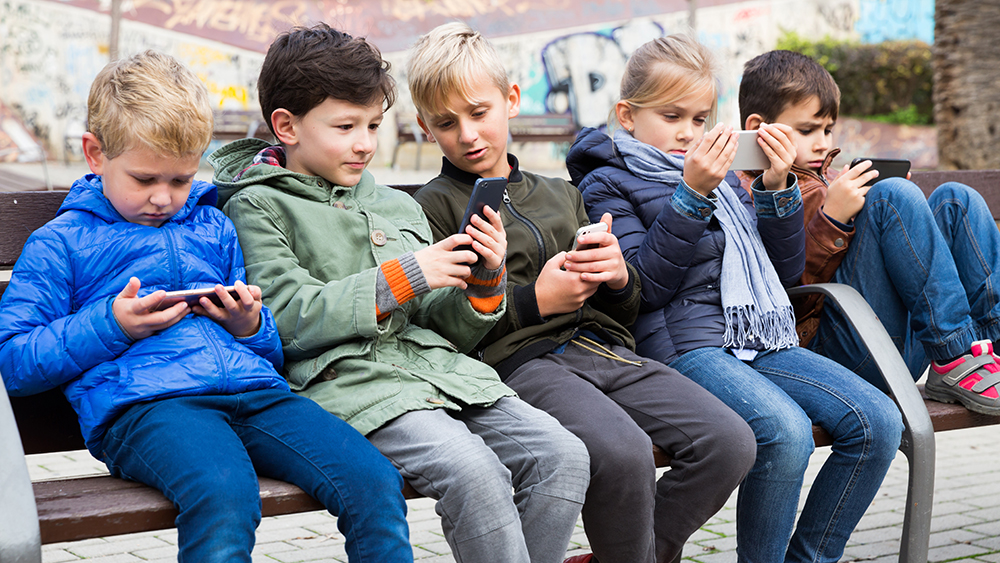 A group of children looking at their phones