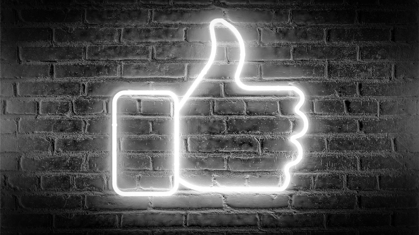 Neon "like" sign on a brick wall