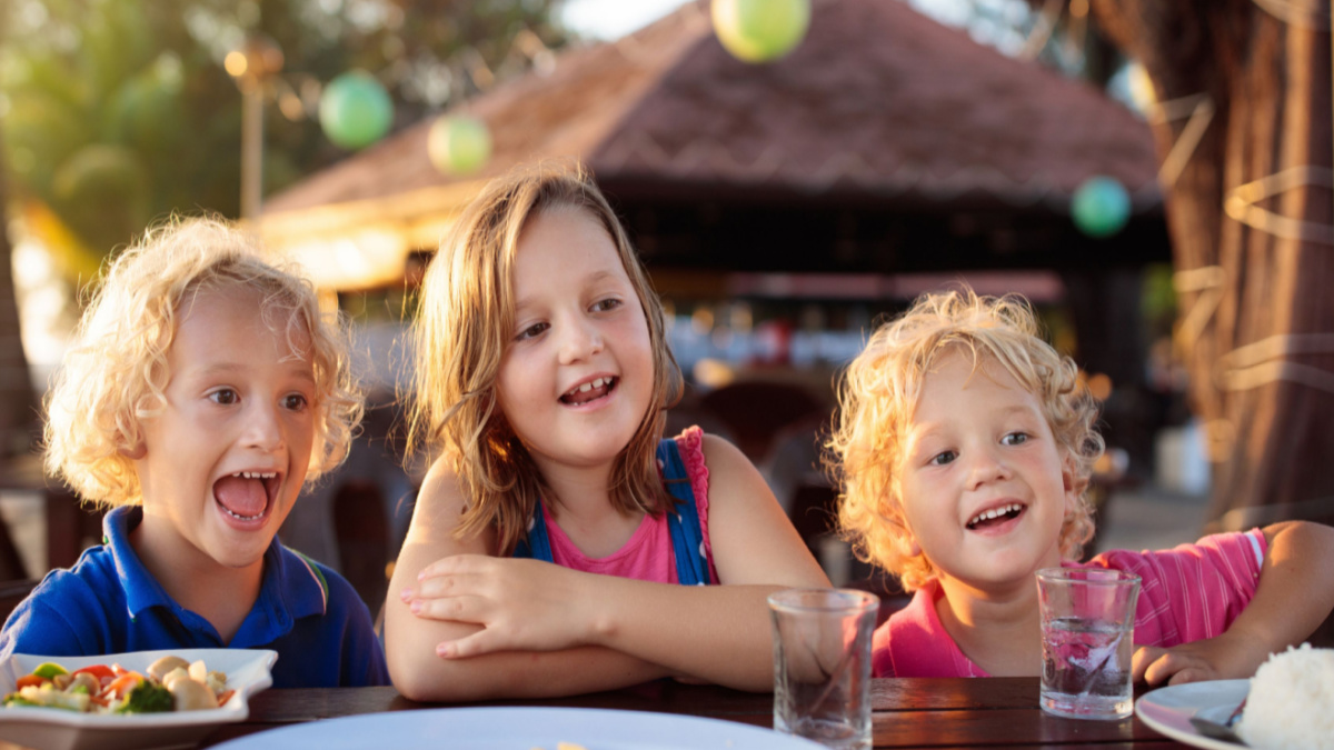 Three children having a family meal