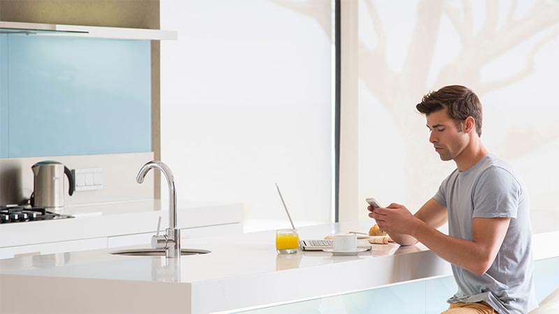 Clean kitchen worktop with a person preparing breakfast in normal lighting